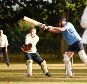 Action shot of batting and catching